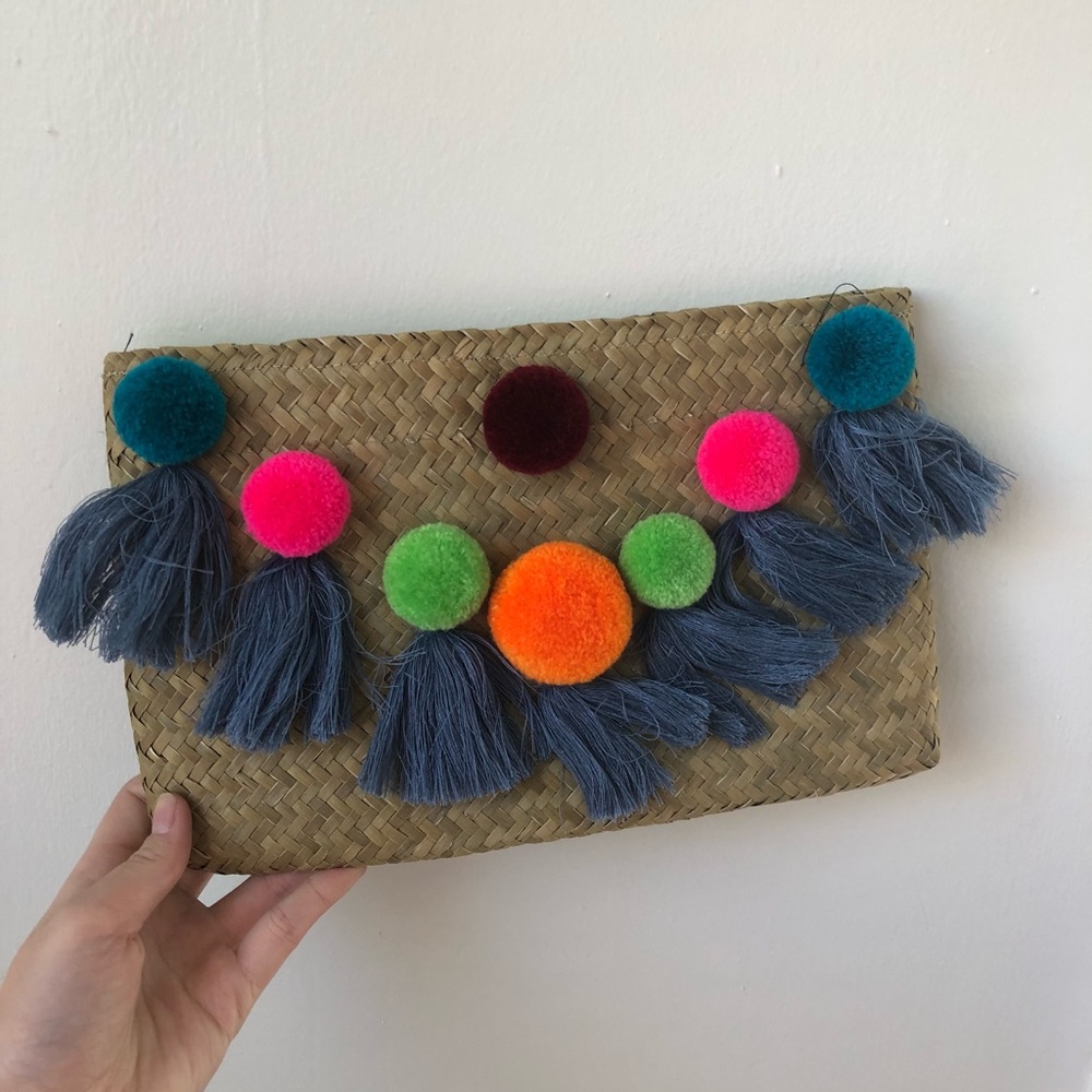 Weaved Basket Clutch With Colorful Pom Detail.